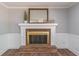 Close up of living room fireplace with wood flooring, brick hearth and Gathering decor at 714 Lanford Springs Sw Dr, Lilburn, GA 30047