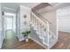 Bright entryway featuring wood-look floors, a staircase, and modern decor that leads into the house at 714 Lanford Springs Sw Dr, Lilburn, GA 30047