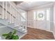 Inviting foyer with decorative white front door, showcasing the staircase, and modern vinyl floors at 714 Lanford Springs Sw Dr, Lilburn, GA 30047