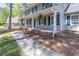 Welcoming front porch with classic white columns and dark shutters, providing a shaded outdoor space at 714 Lanford Springs Sw Dr, Lilburn, GA 30047