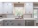 Kitchen features a stainless steel sink, modern faucet, white cabinets, quartz countertops, subway tile backsplash, and stainless dishwasher at 714 Lanford Springs Sw Dr, Lilburn, GA 30047