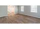 Spacious living room with vinyl floors and natural light streaming through the large windows at 714 Lanford Springs Sw Dr, Lilburn, GA 30047