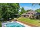 Aerial shot of backyard with pool, gazebo, and well-maintained lawn, surrounded by lush trees at 8925 Huntcliff Lake Ct, Atlanta, GA 30350