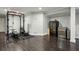 Finished basement features a home gym, dark wood flooring, and a wine fridge at 8925 Huntcliff Lake Ct, Atlanta, GA 30350