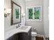 Powder room with modern vanity, marble countertops, framed mirror, and a window for natural light at 8925 Huntcliff Lake Ct, Atlanta, GA 30350