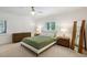 Bright bedroom featuring a ceiling fan, neutral carpet, and light-colored walls at 8925 Huntcliff Lake Ct, Atlanta, GA 30350