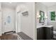 Hallway featuring hardwood floors, a coat rack, access to the powder room, and front door at 8925 Huntcliff Lake Ct, Atlanta, GA 30350