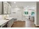 Spacious kitchen with stainless appliances, ample counter space, bar area, and hardwood floors at 8925 Huntcliff Lake Ct, Atlanta, GA 30350