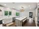 Bright, white kitchen features a large island, stainless steel appliances, and a farmhouse sink at 8925 Huntcliff Lake Ct, Atlanta, GA 30350