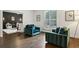 Cozy living room featuring hardwood floors, and comfortable seating with natural light at 8925 Huntcliff Lake Ct, Atlanta, GA 30350
