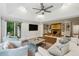 Spacious living room with vaulted ceilings, hardwood floors, brick fireplace, and plenty of natural light at 8925 Huntcliff Lake Ct, Atlanta, GA 30350
