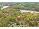 Aerial view of neighborhood with home, trees, and a lake in the distance at 107 Estates At The Lake Dr, Canton, GA 30114