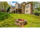 Backyard fire pit with lush lawn and wooded views at 107 Estates At The Lake Dr, Canton, GA 30114