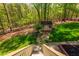 Backyard view from the deck stairs, with a shed, black fence and green grass at 107 Estates At The Lake Dr, Canton, GA 30114