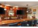 Wood wet bar featuring a large TV, custom lighting, and glass shelving at 107 Estates At The Lake Dr, Canton, GA 30114