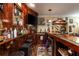 Wet bar features a wooden countertop, TV, sink, and a cabinet full of bar accessories at 107 Estates At The Lake Dr, Canton, GA 30114