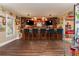 Home bar features a wooden bar top, two TVs, and seating for six at 107 Estates At The Lake Dr, Canton, GA 30114