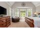 Bright main bedroom with a large bay window, natural light, and comfortable chair at 107 Estates At The Lake Dr, Canton, GA 30114