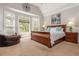 Inviting main bedroom with a large bay window, wood furniture, and a cozy sitting area at 107 Estates At The Lake Dr, Canton, GA 30114