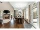 Dining area with fireplace, large windows, wood floors, and access to the deck at 107 Estates At The Lake Dr, Canton, GA 30114