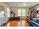 Bright exercise room with hardwood floors, ceiling fan and exercise equipment at 107 Estates At The Lake Dr, Canton, GA 30114
