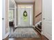 Elegant foyer featuring hardwood floors, stairs, and a decorative front door at 107 Estates At The Lake Dr, Canton, GA 30114