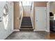 Welcoming foyer boasts hardwood floors, stairs, and a decorative front door, seamlessly blends style and functionality at 107 Estates At The Lake Dr, Canton, GA 30114