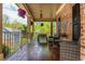 Covered front porch with outdoor seating, decorative lights, and views of the green yard at 107 Estates At The Lake Dr, Canton, GA 30114