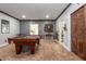 Spacious game room includes a pool table, dart board, and access to another room at 107 Estates At The Lake Dr, Canton, GA 30114