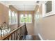Hallway with elegant wood staircase and railing, decorative lighting, and arched windows at 107 Estates At The Lake Dr, Canton, GA 30114
