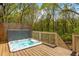 Hot tub on a wood deck with a wooded view and privacy fence at 107 Estates At The Lake Dr, Canton, GA 30114