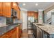 Spacious kitchen boasts stainless steel appliances, granite countertops, and wood flooring at 107 Estates At The Lake Dr, Canton, GA 30114