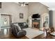 Inviting living room with a fireplace and a comfortable, oversized leather sectional sofa at 107 Estates At The Lake Dr, Canton, GA 30114