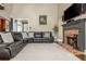 Bright living room features a brick fireplace, flat-screen TV and large leather sectional at 107 Estates At The Lake Dr, Canton, GA 30114