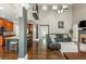 Open-concept living area showcases hardwood floors, a brick fireplace, and seamless access to the kitchen at 107 Estates At The Lake Dr, Canton, GA 30114