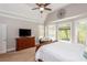 Bright main bedroom boasts natural light, a ceiling fan, and a decorative wall art piece at 107 Estates At The Lake Dr, Canton, GA 30114