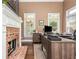 Inviting home office with a brick fireplace, wood floors, and lots of natural light at 107 Estates At The Lake Dr, Canton, GA 30114