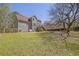 Spacious backyard with lawn and view of the home's exterior at 2433 Idlewood Way, Snellville, GA 30078