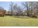 Large backyard with mature trees and swing set in distance at 2433 Idlewood Way, Snellville, GA 30078