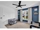 Bedroom with blue accent wall and two cribs next to a large window at 2433 Idlewood Way, Snellville, GA 30078
