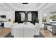 Bright dining room with a pendant light fixture over a glossy white table and ample natural light at 2433 Idlewood Way, Snellville, GA 30078