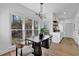 Bright dining room featuring modern light fixture, light wood floors, and multiple large windows at 2433 Idlewood Way, Snellville, GA 30078