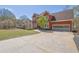 Brick two-story home with a well-manicured lawn and large driveway leading to an attached two car garage at 2433 Idlewood Way, Snellville, GA 30078