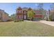 Charming brick two-story home with a well-manicured lawn and attached two car garage on a sunny day at 2433 Idlewood Way, Snellville, GA 30078