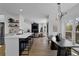 Open-concept kitchen with sleek bar seating, which connects to a living area with hardwood flooring at 2433 Idlewood Way, Snellville, GA 30078