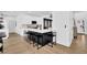 Eat-in kitchen showcasing breakfast bar, black accents, white cabinets, and stainless steel appliances at 2433 Idlewood Way, Snellville, GA 30078