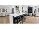 Stylish kitchen with bar seating opens up to an adjacent living and dining area at 2433 Idlewood Way, Snellville, GA 30078