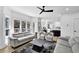 Open-concept living room connected to the kitchen features large windows and stylish furniture at 2433 Idlewood Way, Snellville, GA 30078