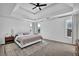 Spacious main bedroom boasts trey ceilings, a ceiling fan, and bright light from dual windows at 2433 Idlewood Way, Snellville, GA 30078