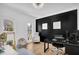 Home office featuring a black accent wall and hardwood floors at 2433 Idlewood Way, Snellville, GA 30078